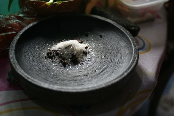 Mortar with spices ready to be ground into a paste for cooking