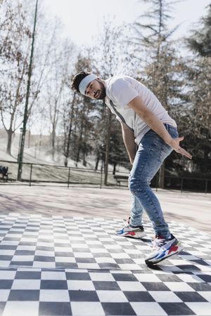 Man dancing break dance in park