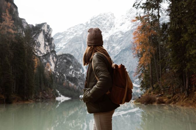 Woman delighting in views near lake and mountains
