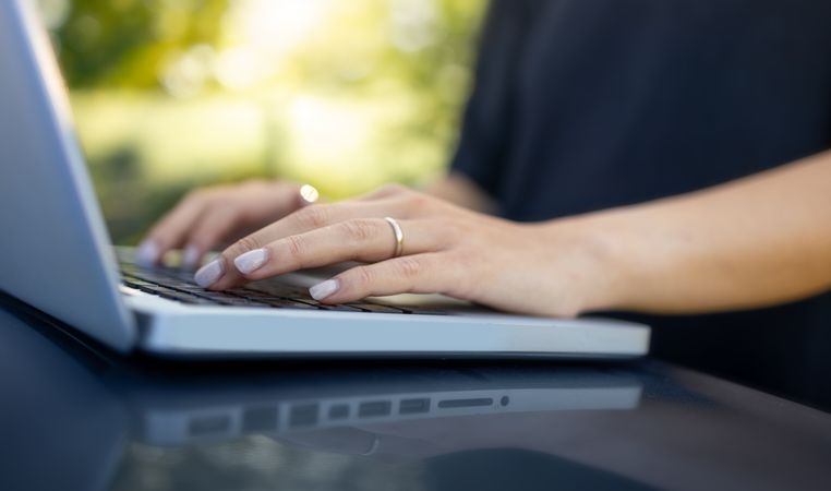 Woman Working Outdoors with Laptop
