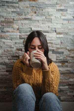 Woman drinking hot tea at home