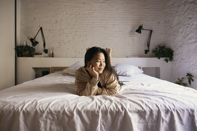 Portrait of young woman on bed