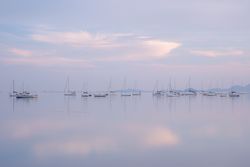Boats on calm sea water in evening