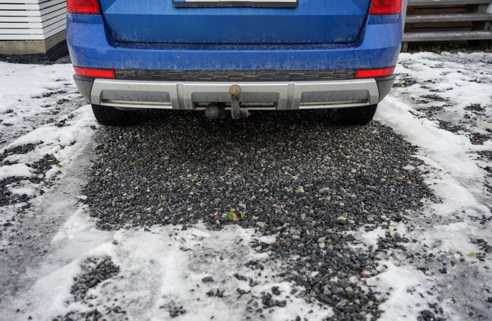 Blue car on iced yard in wintertime