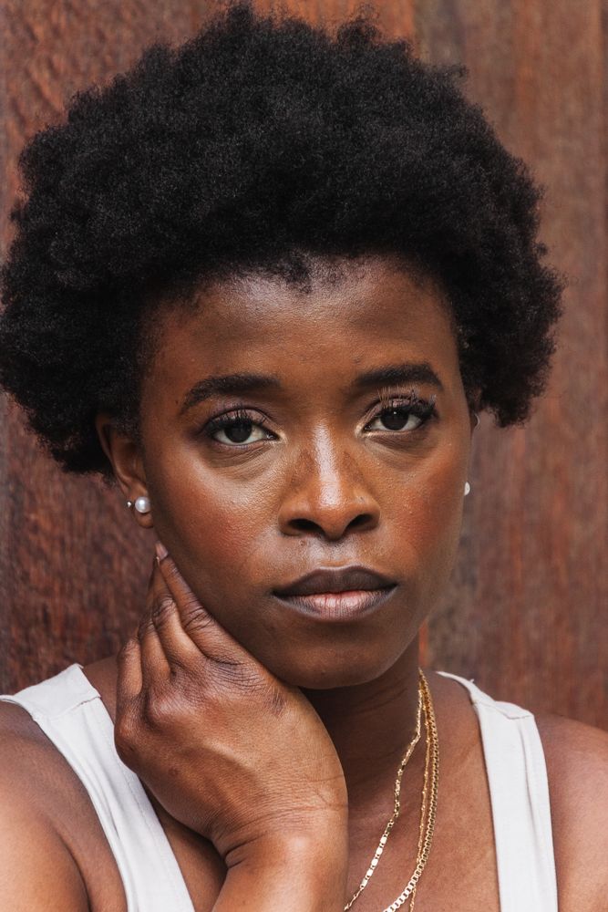 Sad Black woman with Afro hairstyle looking at camera