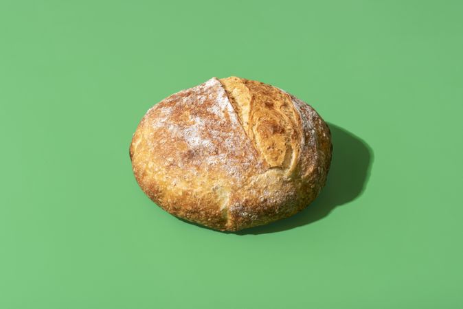 Homemade bread minimalist on a green background
