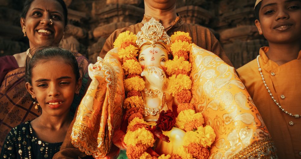 Authentic Portrait of an Indian Man in Traditional Attire Playing Instruments in an Ancient Hindu Temple.