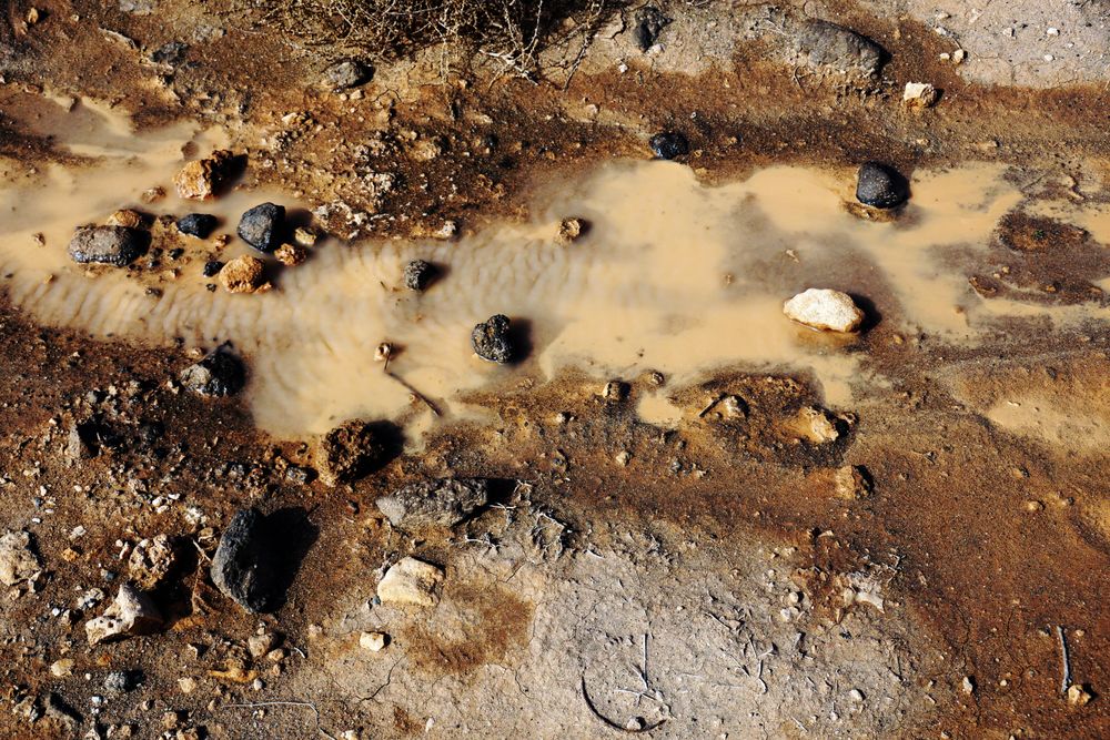 Dirty clay water with rocks