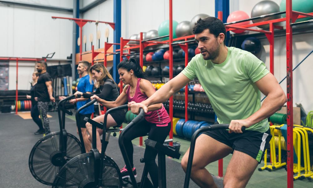 Athletes doing air bike indoor