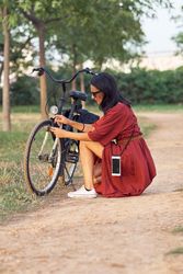 Traveling female tourist fixing bicycle