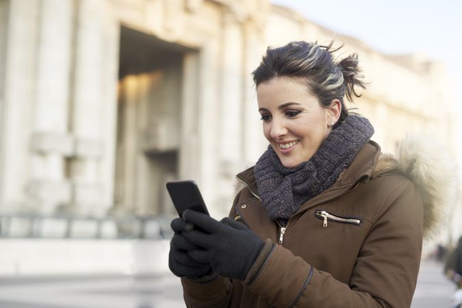 Young woman using smart phone outdoors