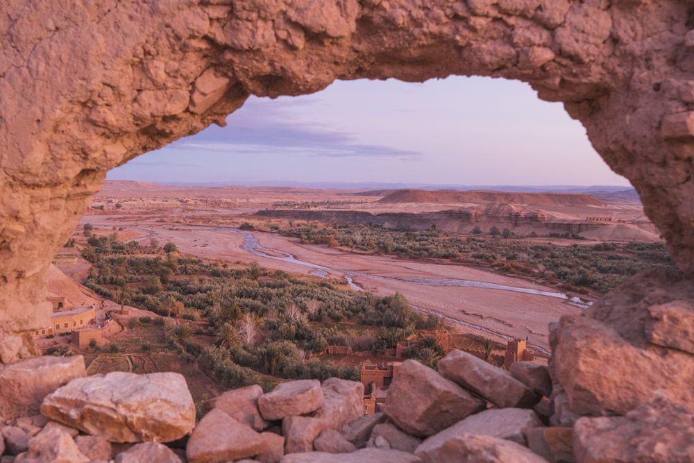 Stones with round hole and view on valley with river