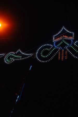 Glowing sign of amusement ride on fairground