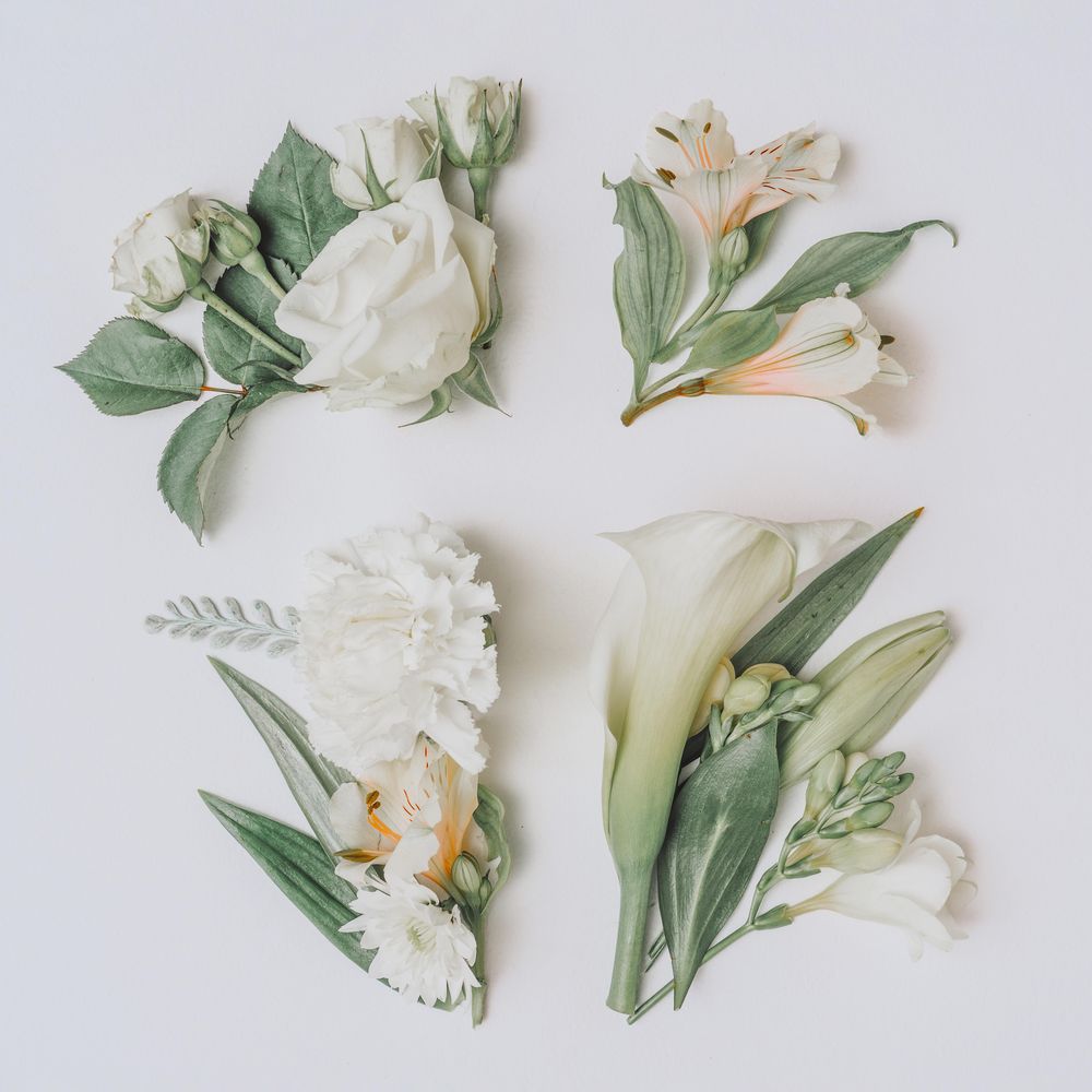 Easter layout with flowers and leaves in cross shape on light paper background