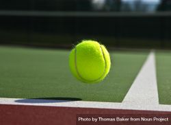 Tennis ball bouncing off the baseline 5XBokb