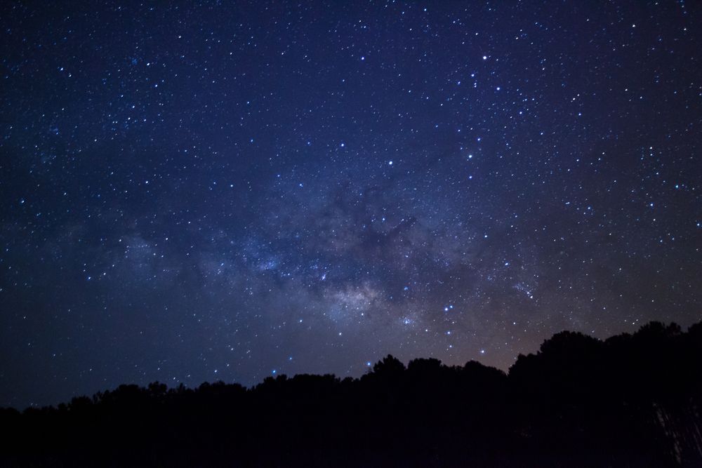 Milky way galaxy with stars and space dust in the universe at PhuHinRongkla Ntional Park