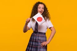 Cheerful girl holding Japanese flag