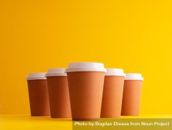 Disposable coffee cups on yellow background 0PEOl5