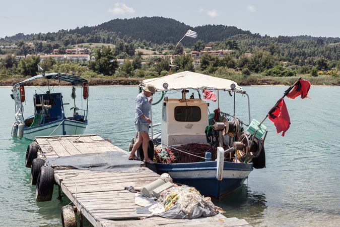Woman boarding on boat near pier
