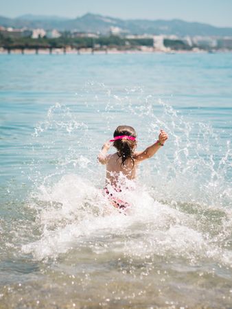 Cheerful girl having fun in warm sea