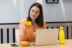 Happy woman making payment during online shopping