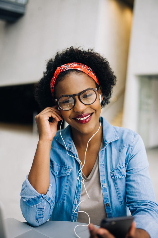 Woman listening to music or a call through her earbuds