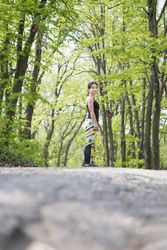 Athletic woman standing looking to her side in the forest