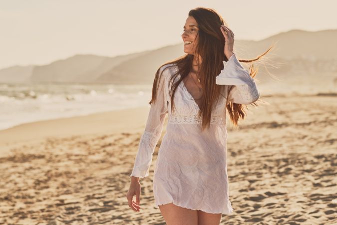 Young woman at the beach at sunset