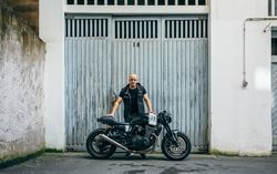 Builder posing with a motorcycle