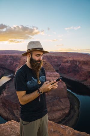 Traveler on the mobile phone near canyon