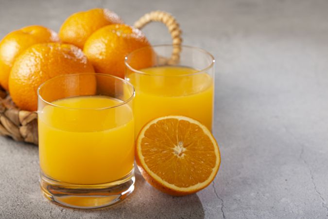 Glass with orange juice on the table.