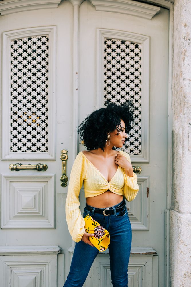 Fashionable Black female by gray door