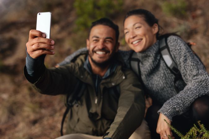 Couple hiking taking selfie with smart phone