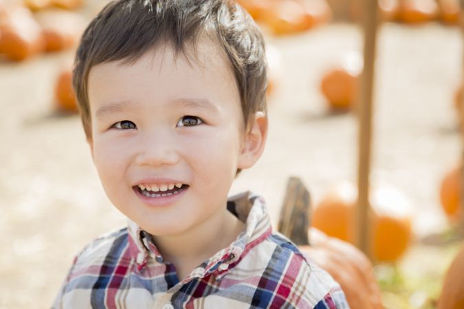 Young Boy Smiling at the Pumpkin Patch