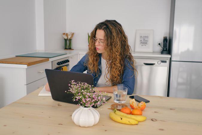 Businesswoman working on laptop at home