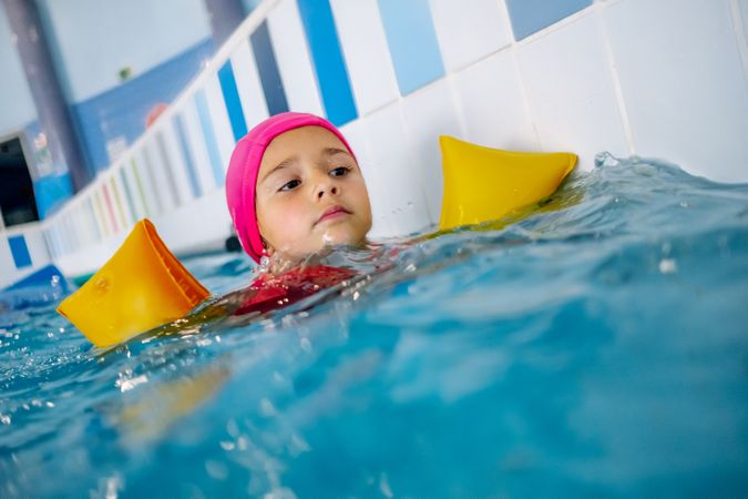 girl with water wings in swimming pool