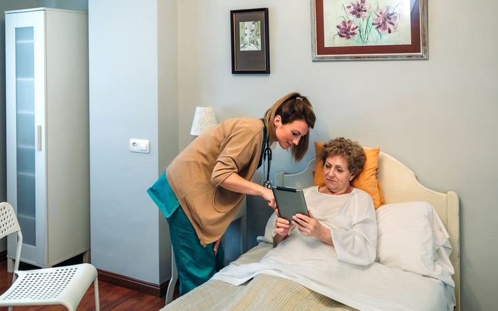 Female doctor showing results of a medical test on the tablet