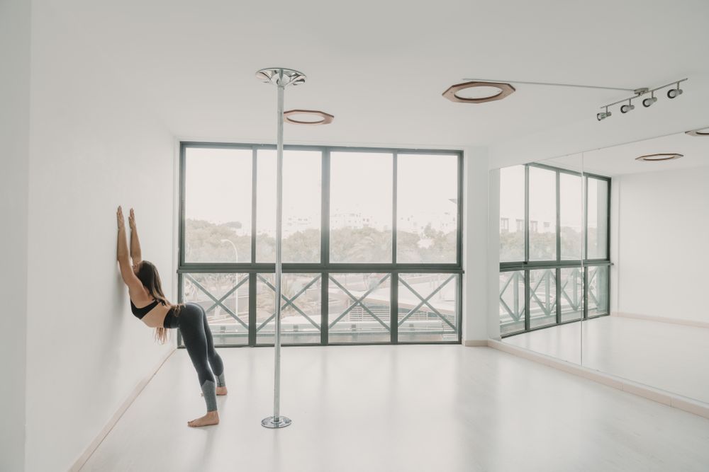 Flexible woman stretching in studio