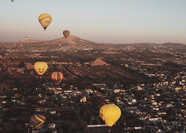 Group of hot air balloons in flight over pyramids in Teotihuacan Valley