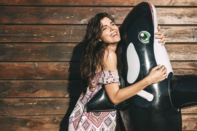 Woman hugging an inflatable killer whale