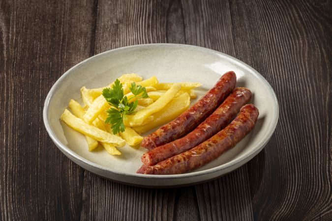 Grilled German sausage with french fries.