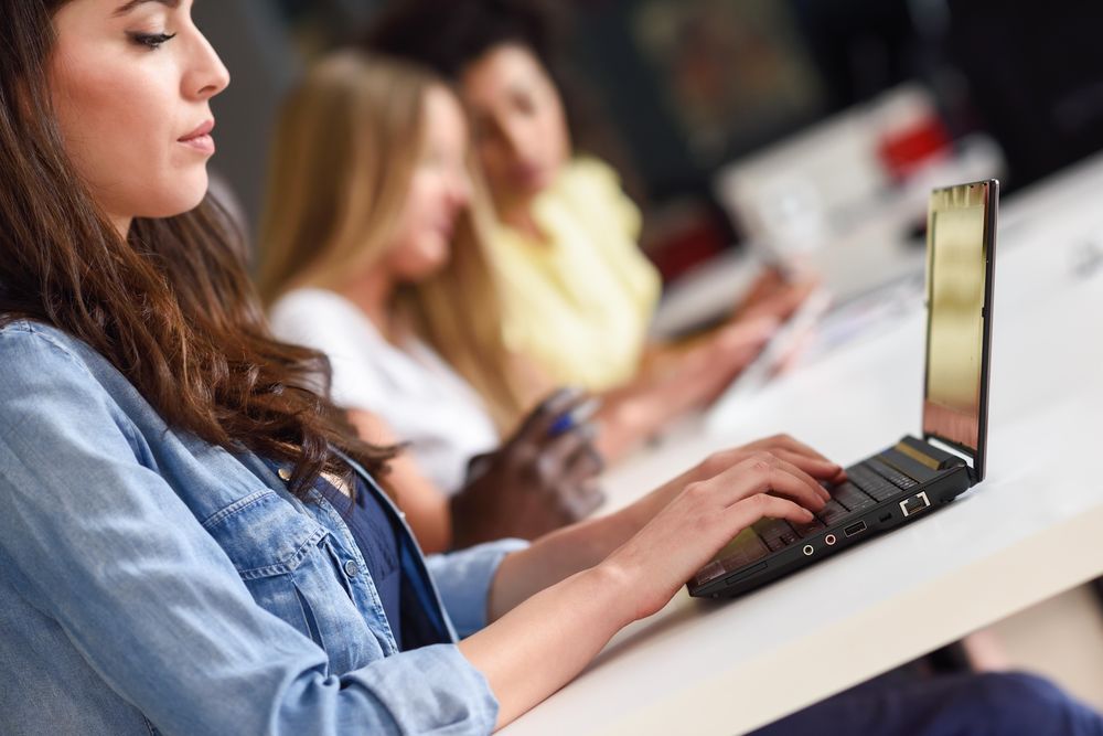 Side view of woman working on her laptop