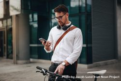Businessman using mobile phone while going to office 4mmZo4