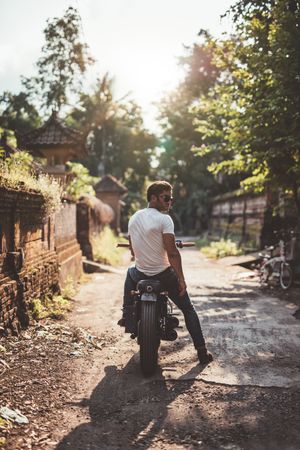 Outdoor shot of young man sitting on his motorcycle
