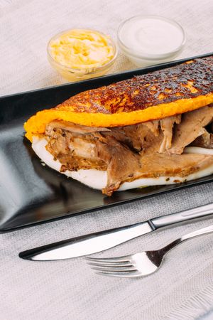 Cachapa, typical Venezuelan dish made with corn and stuffed with cheese and pork