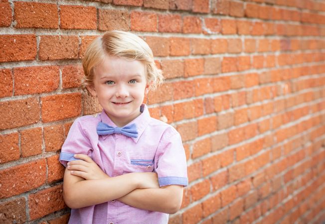 Cute Young Boy Portrait Against A Brick Wall