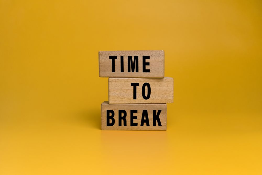 time to break words text on wooden blocks isolated on orange background