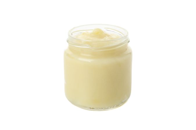 Glass jar with healthy baby food isolated on plain background
