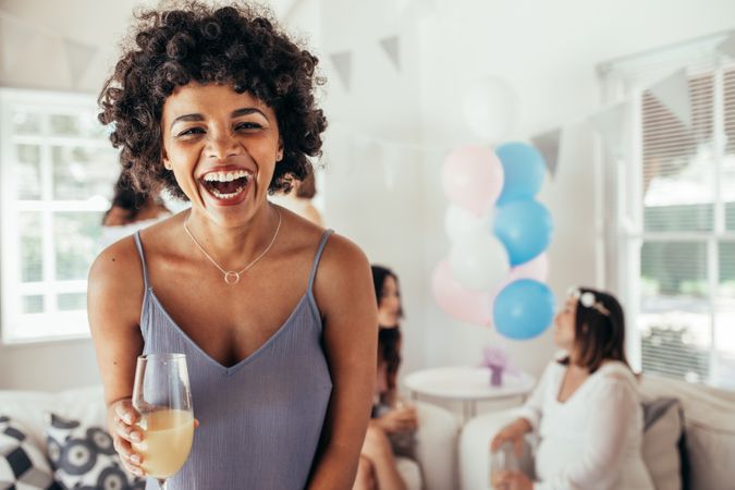 Laughing Black woman at friend's baby shower
