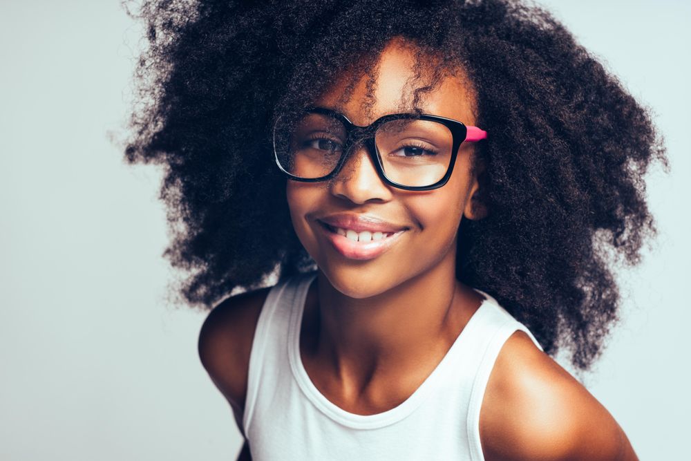 Studio portrait of confident girl wearing oversized glasses